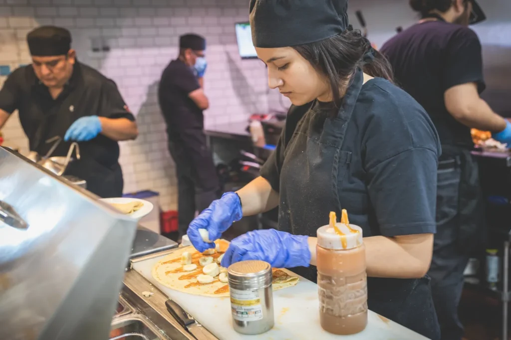 Taste of Paris team preparing crêpes at the counter.