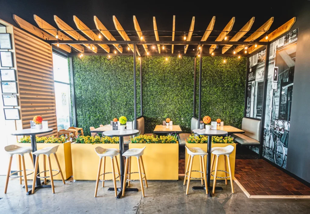 Dining tables beside the green wall at Taste of Paris.