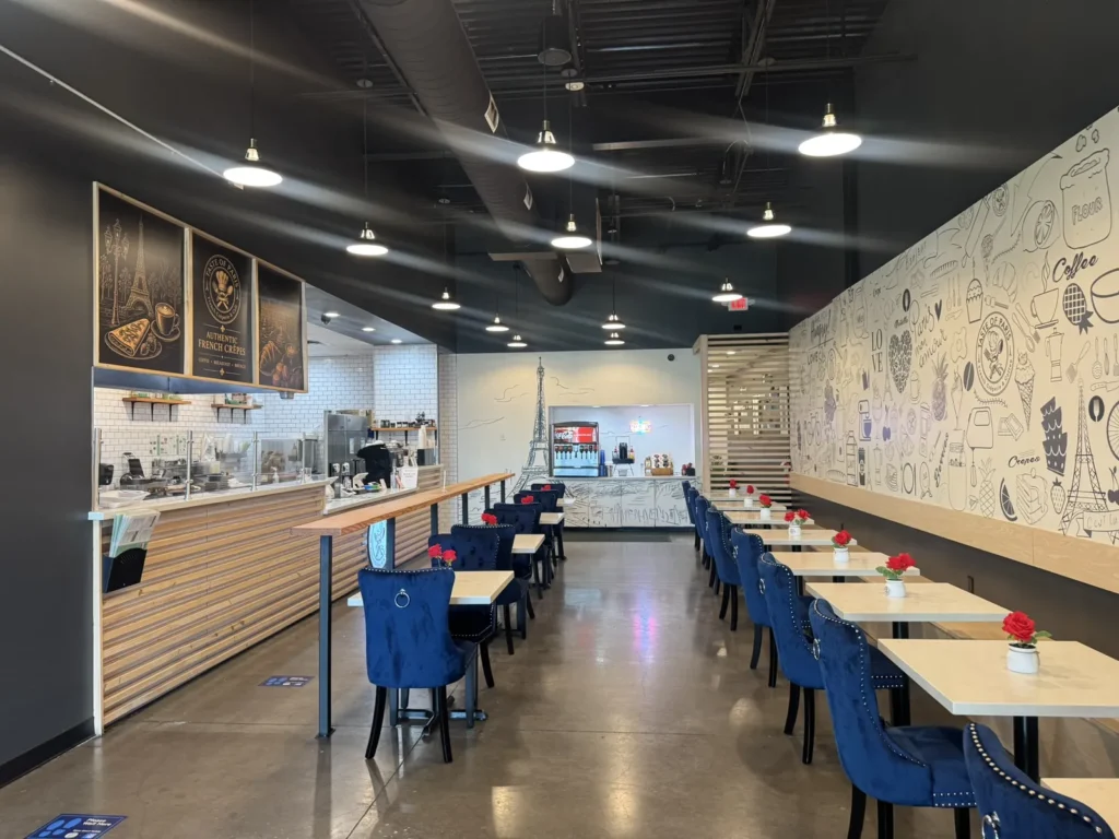 Taste of Paris counter and dining room with blue chairs.