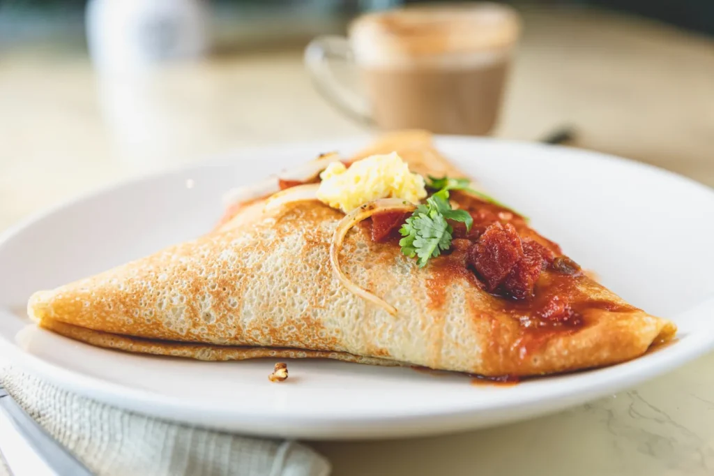 Spanish Ranchero breakfast crêpe served on a white plate.